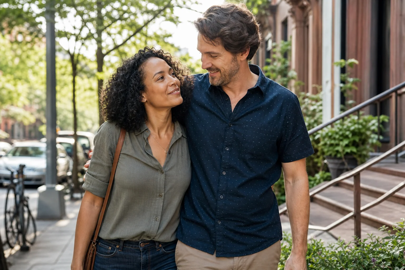 A couple walking together on a sunny neighborhood street